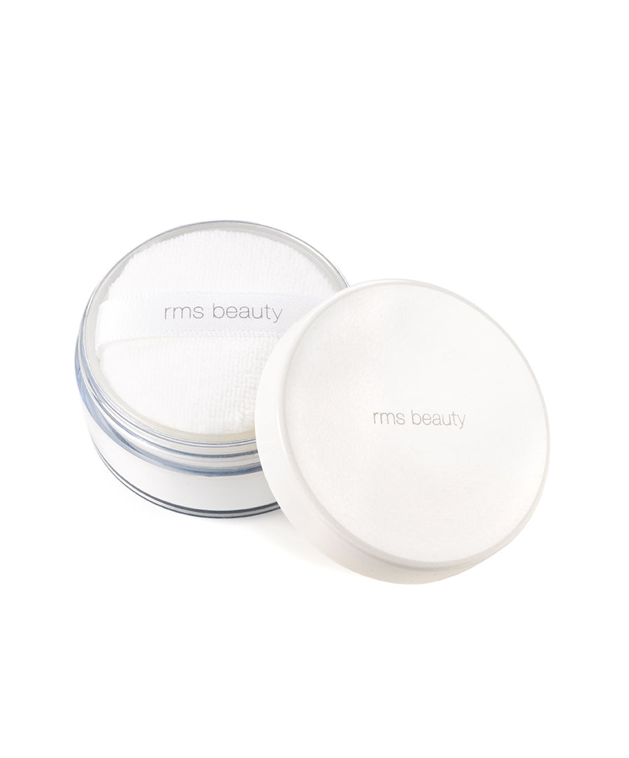 Open container of white RMS Beauty UnPowder with soft puff applicator inside, loose setting powder for natural makeup finish in recyclable packaging.