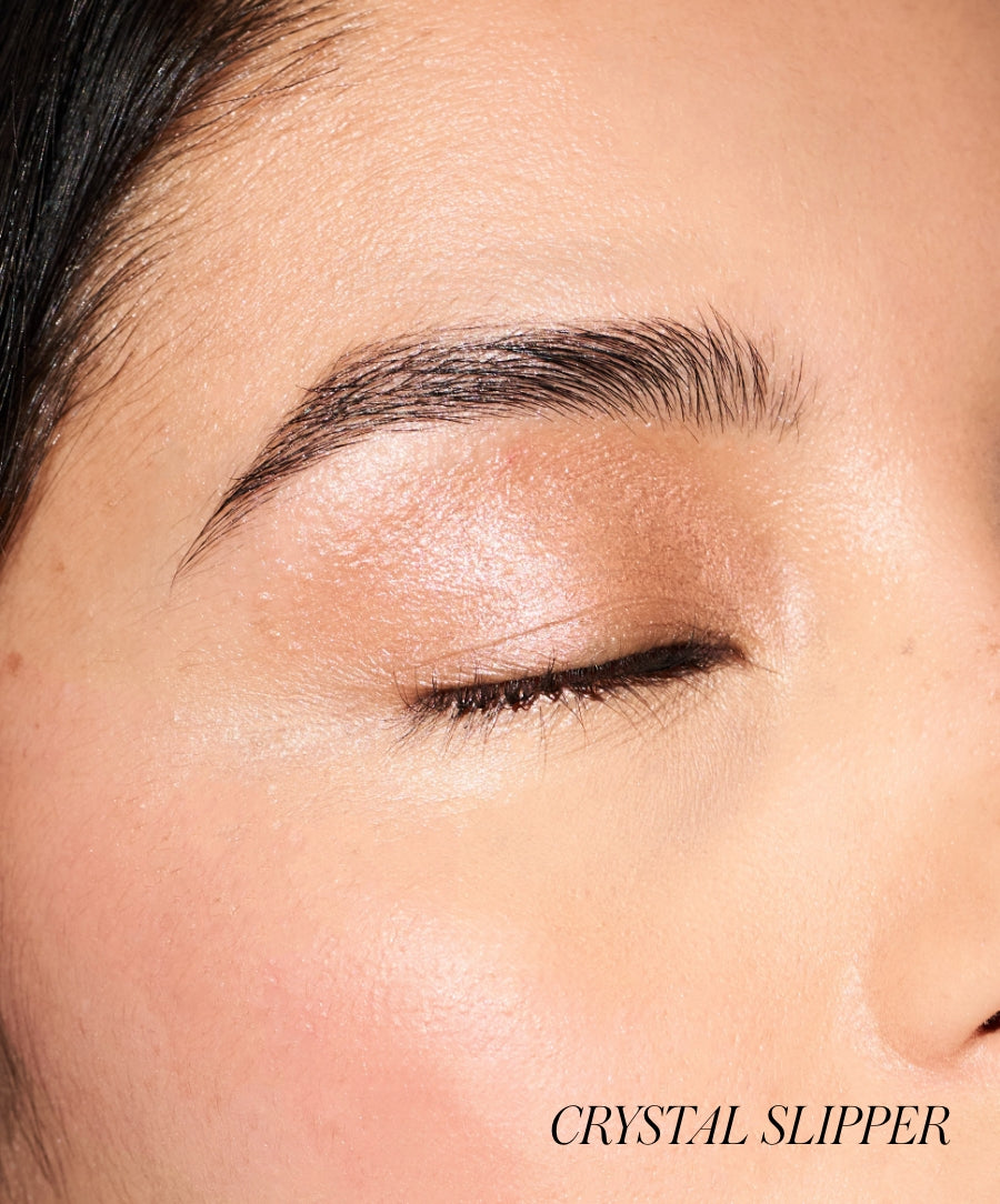 Close-up of a closed eye wearing Eyelights Cream Eyeshadow in a soft, shimmering crystal shade, highlighting smooth skin and natural makeup with clean beauty ingredients.