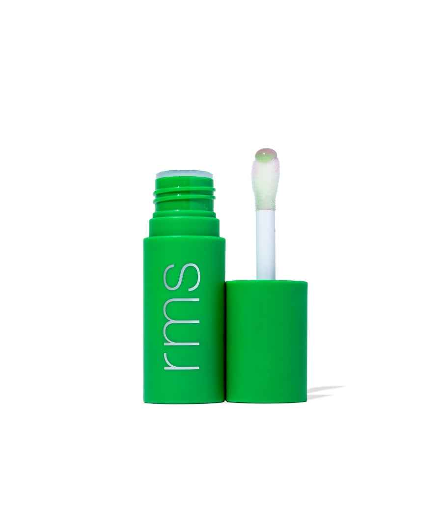 Open green tube of Legendary Lip Oil with applicator wand showing translucent tinted lip oil drop, featuring clean beauty and natural ingredients by RMS Beauty.