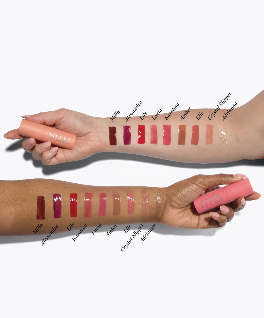 Two arms with different skin tones showing swatches of RMS Beauty Legendary Lip Oil shades in various natural and pink hues, held alongside matching lip oil tubes in peach and coral packaging.