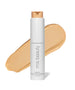 ReEvolve Natural Finish Liquid Foundation in a white cylindrical bottle with a beige liquid foundation swatch behind it, showcasing clean beauty and natural ingredients by RMS Beauty.