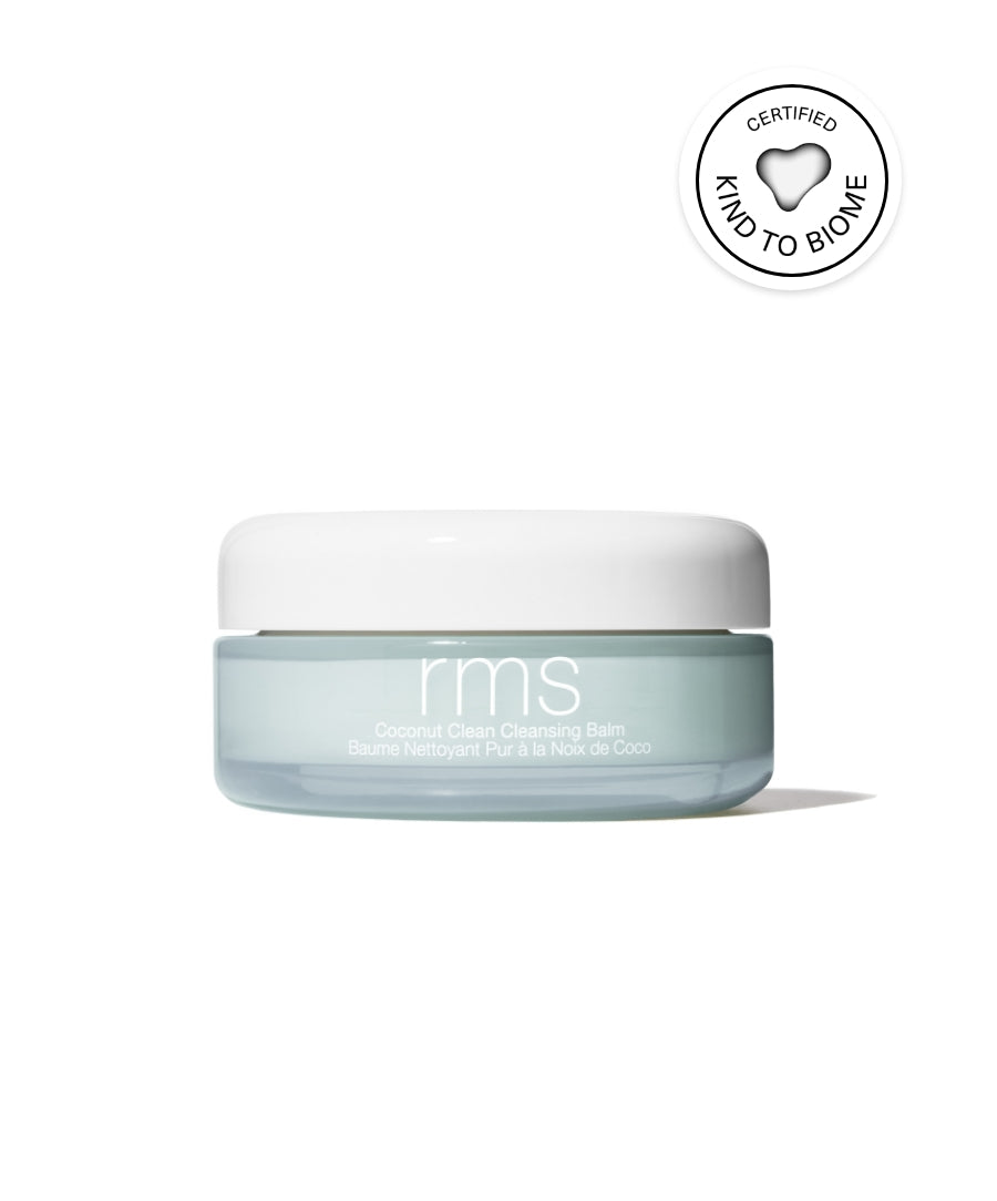 Jar of Coconut Clean Cleansing Balm by RMS Beauty in a light blue container with a white lid, featuring a certified kind to biome seal, promoting clean beauty and natural ingredients.