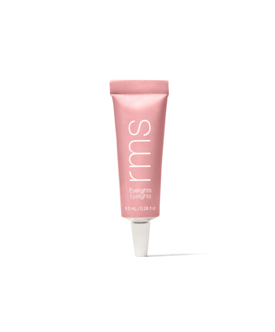 Pink squeeze tube of Eyelights Cream Eyeshadow by RMS Beauty against a white background, showcasing clean beauty and sustainable packaging.
