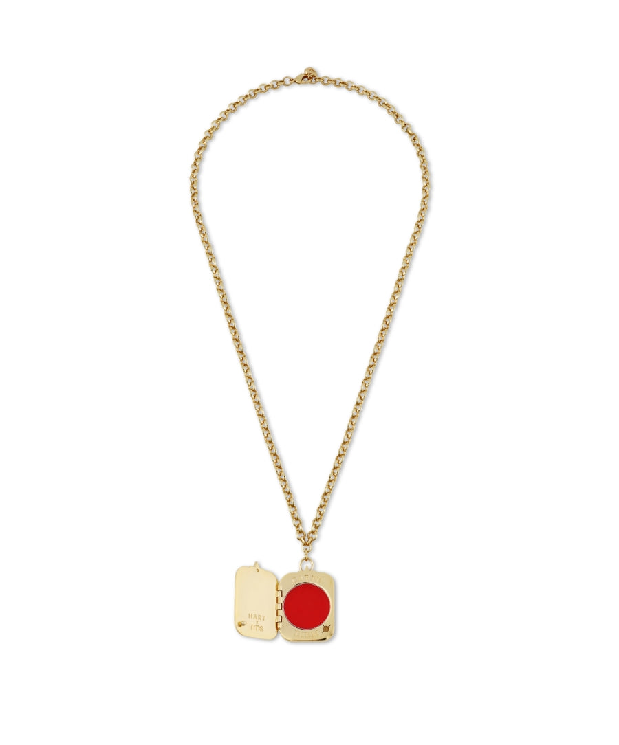 HART x RMS: Lip2Cheek Locket featuring a gold chain with an open locket holding a vibrant red lip and cheek color, combining clean beauty and elegant sustainable packaging.
