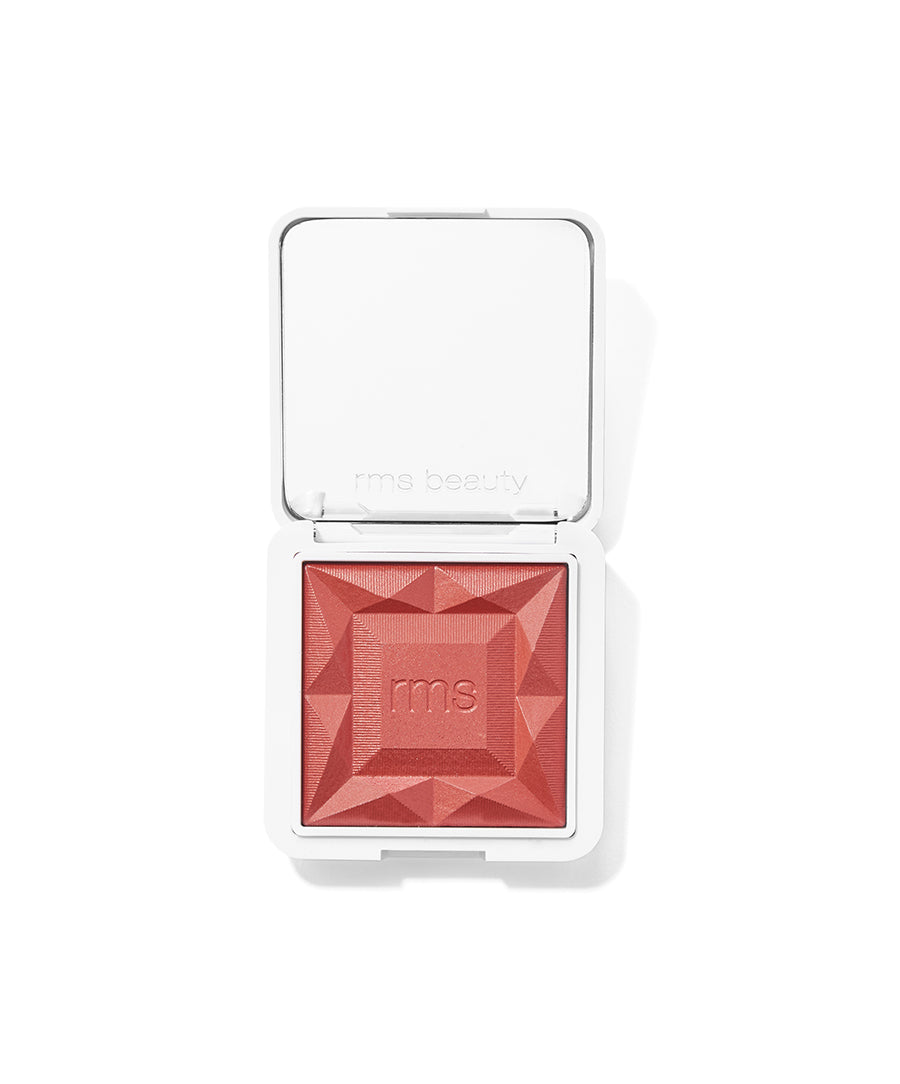 ReDimension Hydra Powder Blush in a warm reddish shade with a geometric embossed surface, housed in a sleek white compact designed for clean beauty and cruelty-free makeup.