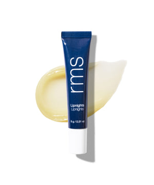 Tube of Lipnights Overnight Lip Mask in navy blue packaging resting on a smooth, creamy balm swatch with a clean white background.