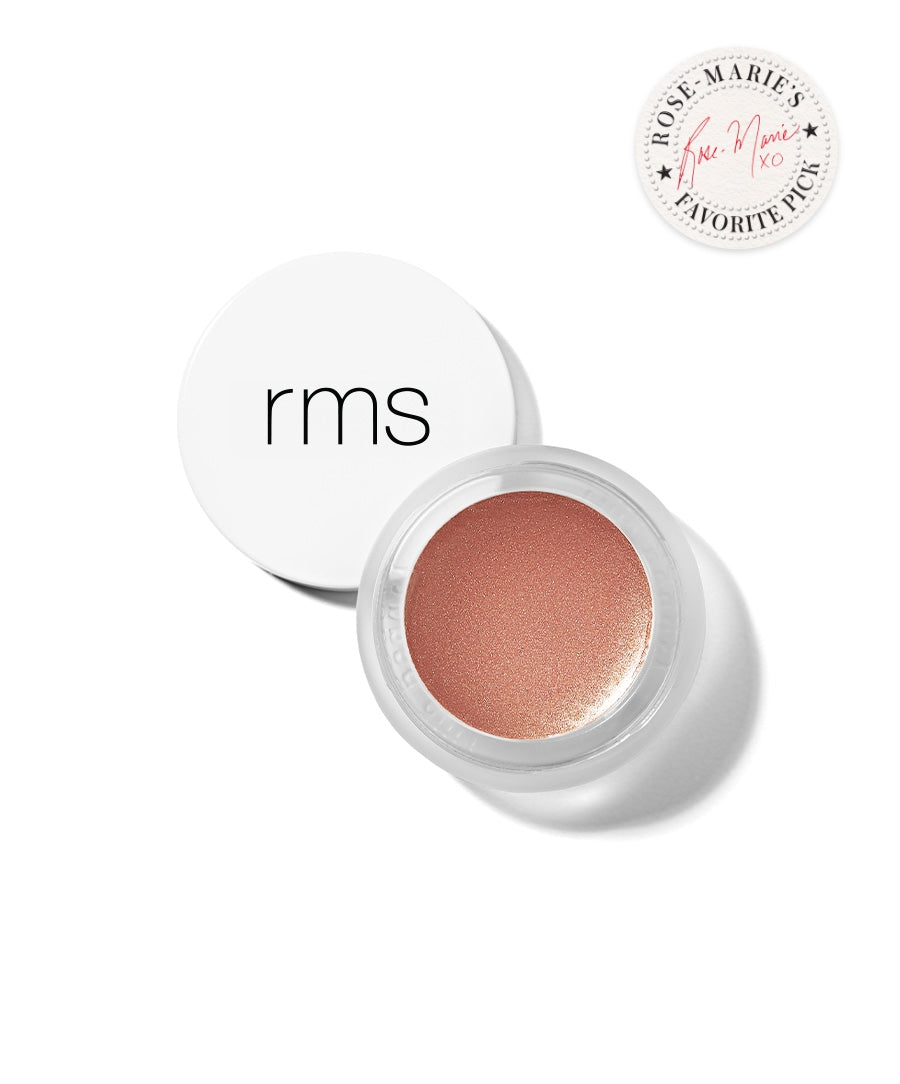 Open jar of peach-toned RMS Beauty Luminizer makeup with white lid and Rose-Marie’s Favorite Pick badge, highlighting clean beauty and natural ingredients.
