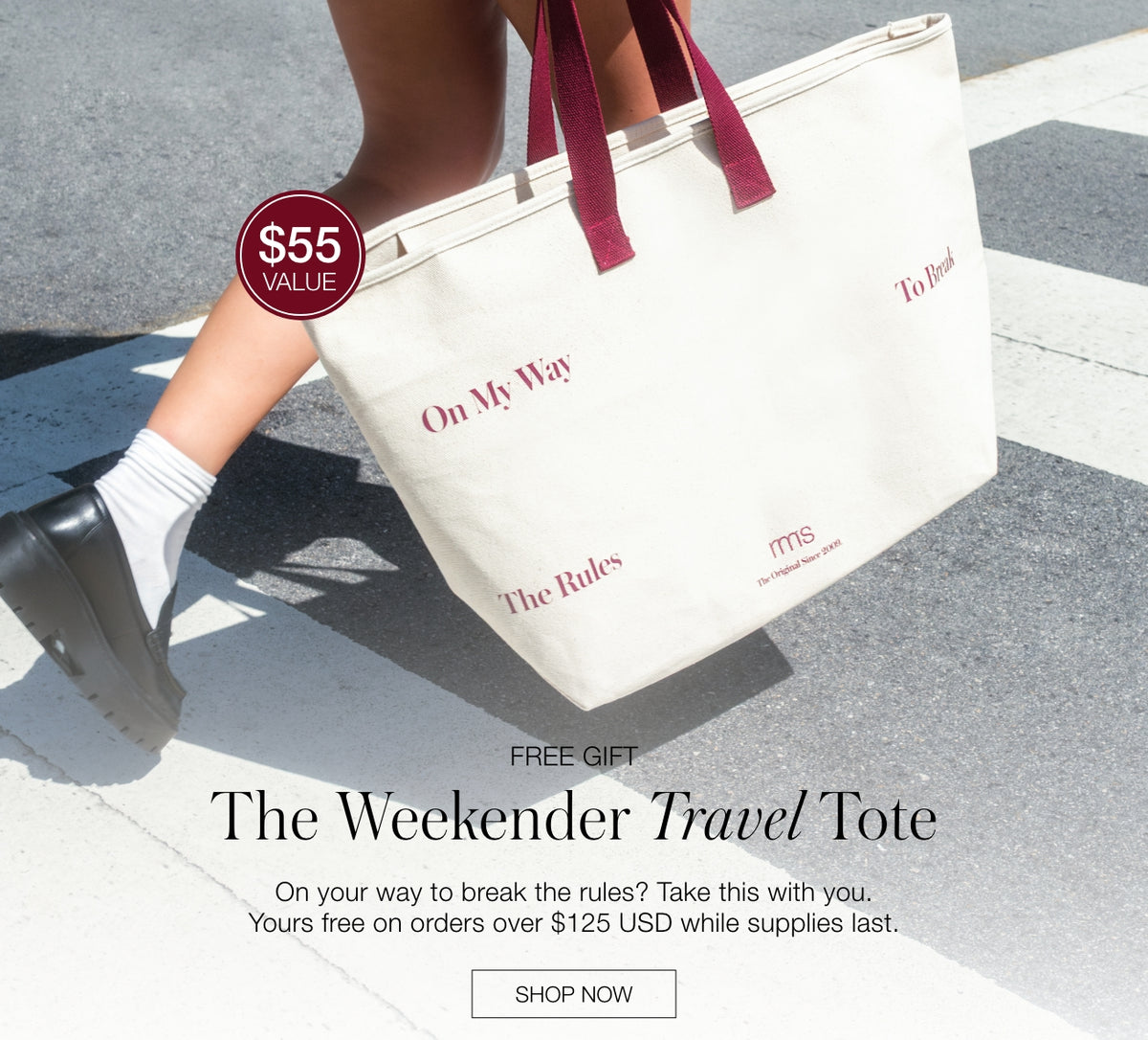 Website graphic showing a cream canvas tote with burgundy handles and printed text beside the words Free Gift and The Weekender Travel Tote.