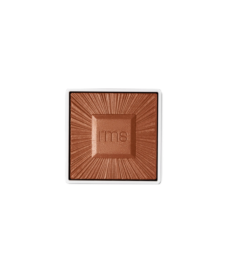 ReDimension Hydra Bronzer compact with radiant bronze shade embossed with "rms" logo, featuring a sunburst pattern, showcasing clean beauty and natural ingredients.