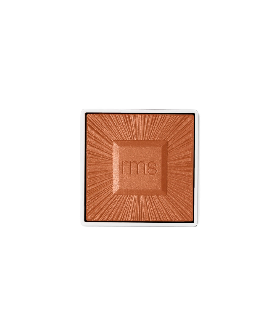 Square compact pan of ReDimension Hydra Bronzer with a warm bronze color and embossed radiating pattern, featuring the RMS Beauty logo at the center.