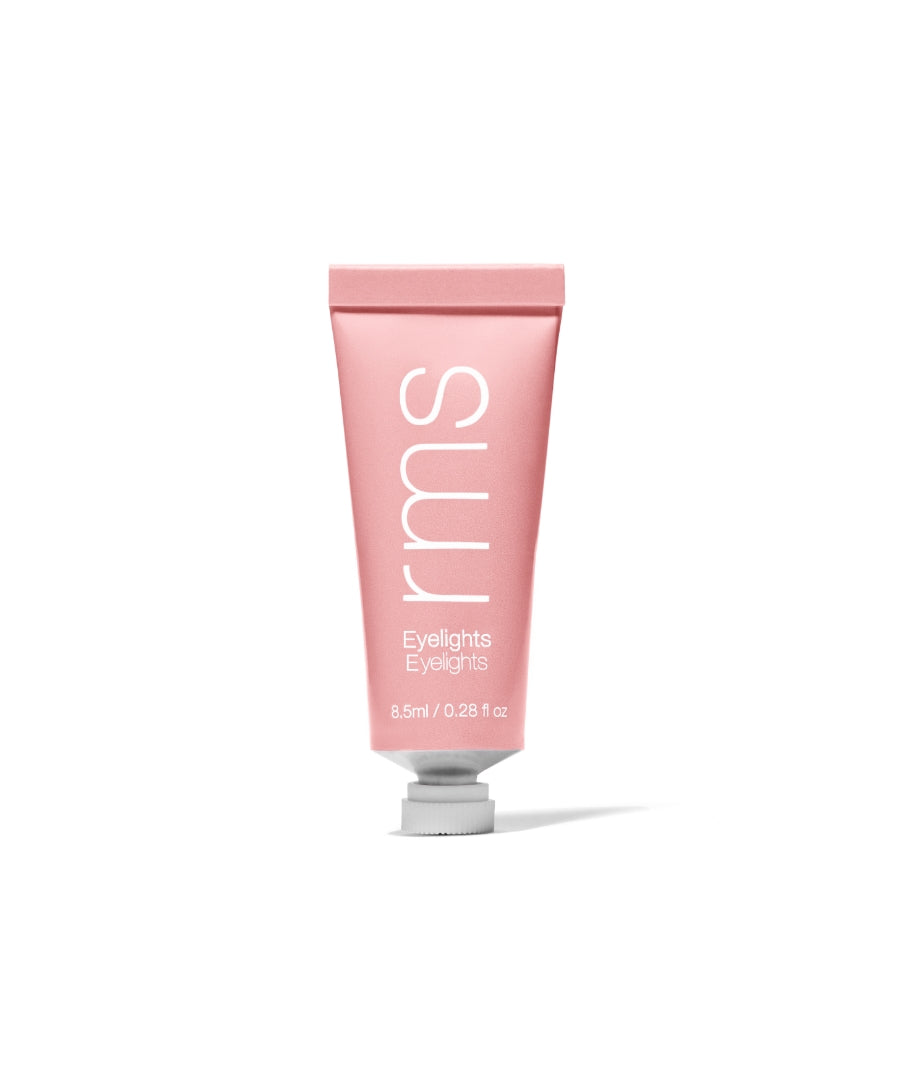 Pink tube of Eyelights Cream Eyeshadow by rms beauty standing upright with clean, minimalist design and white text on the front.