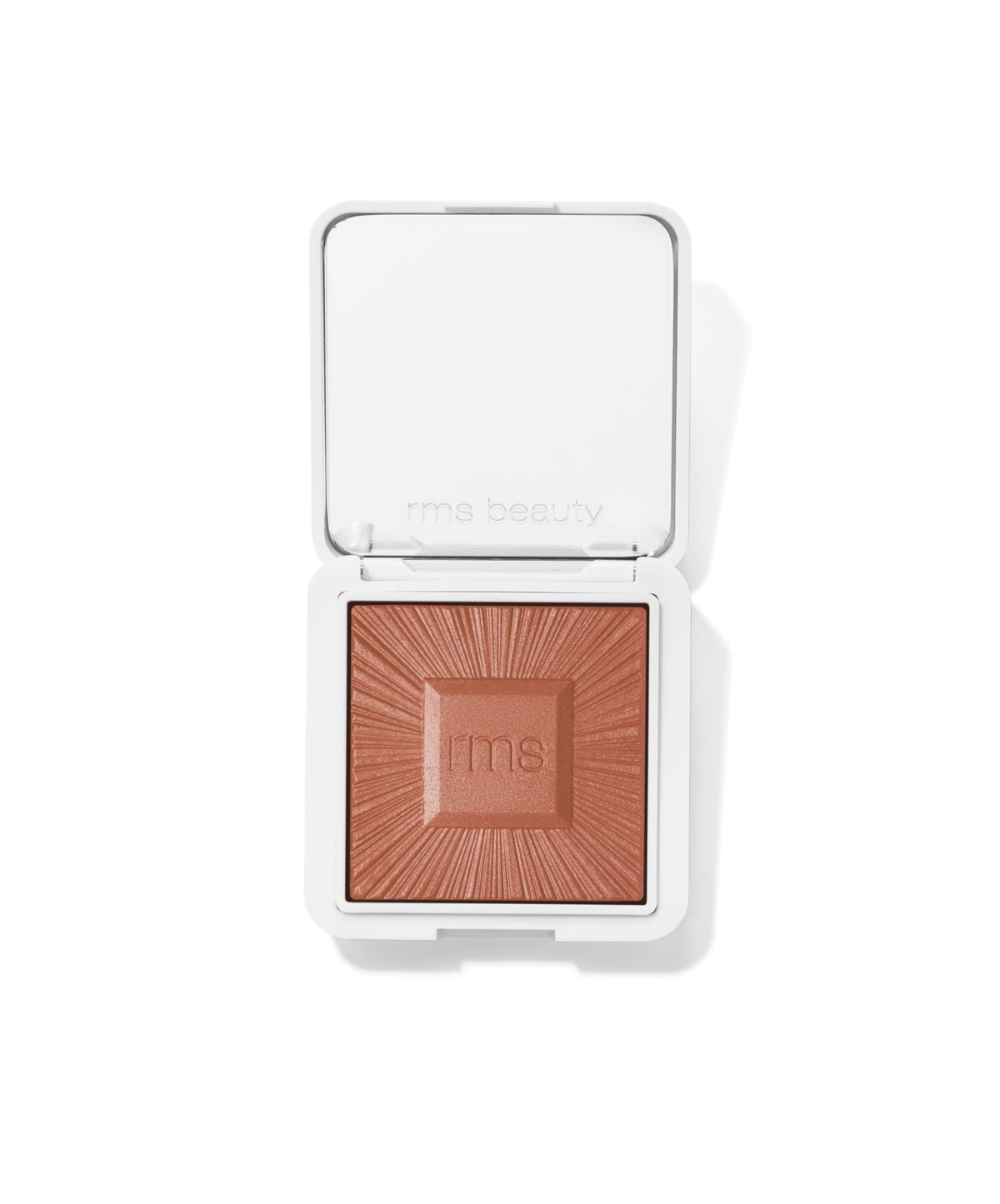 Compact powder makeup in warm brown shade with embossed sunburst design and "rms" logo on surface, in a white square case, ReDimension Hydra Bronzer.