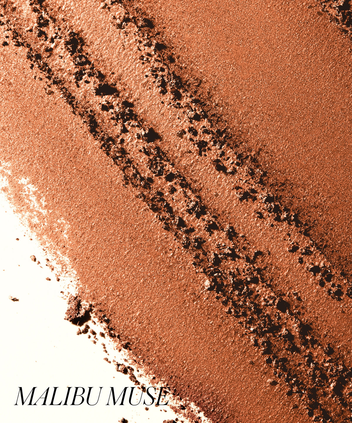 Close-up of warm, natural-toned powdered makeup in Malibu Muse shade with smooth and textured strokes, showcasing ReDimension Hydra Bronzer’s rich color and finish.