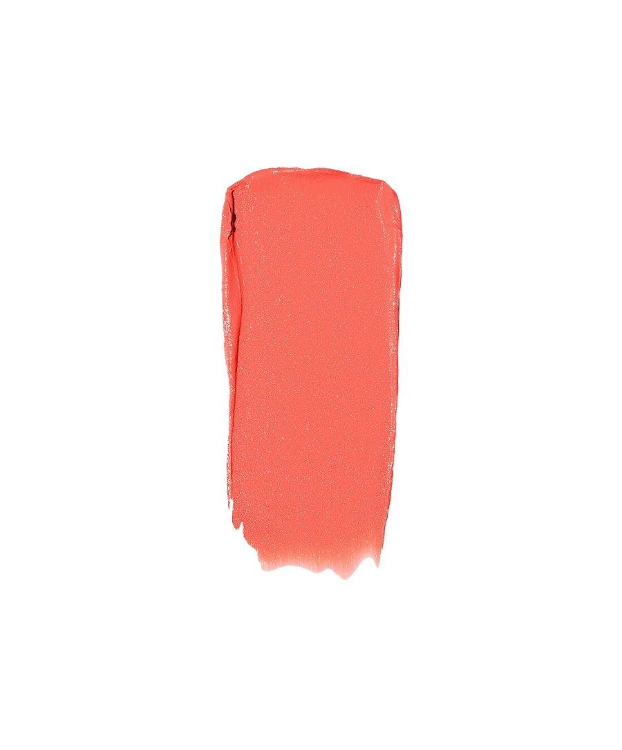 A smooth, coral-colored swatch of Lip2Cheek showcasing its creamy texture and natural, clean beauty makeup formula.
