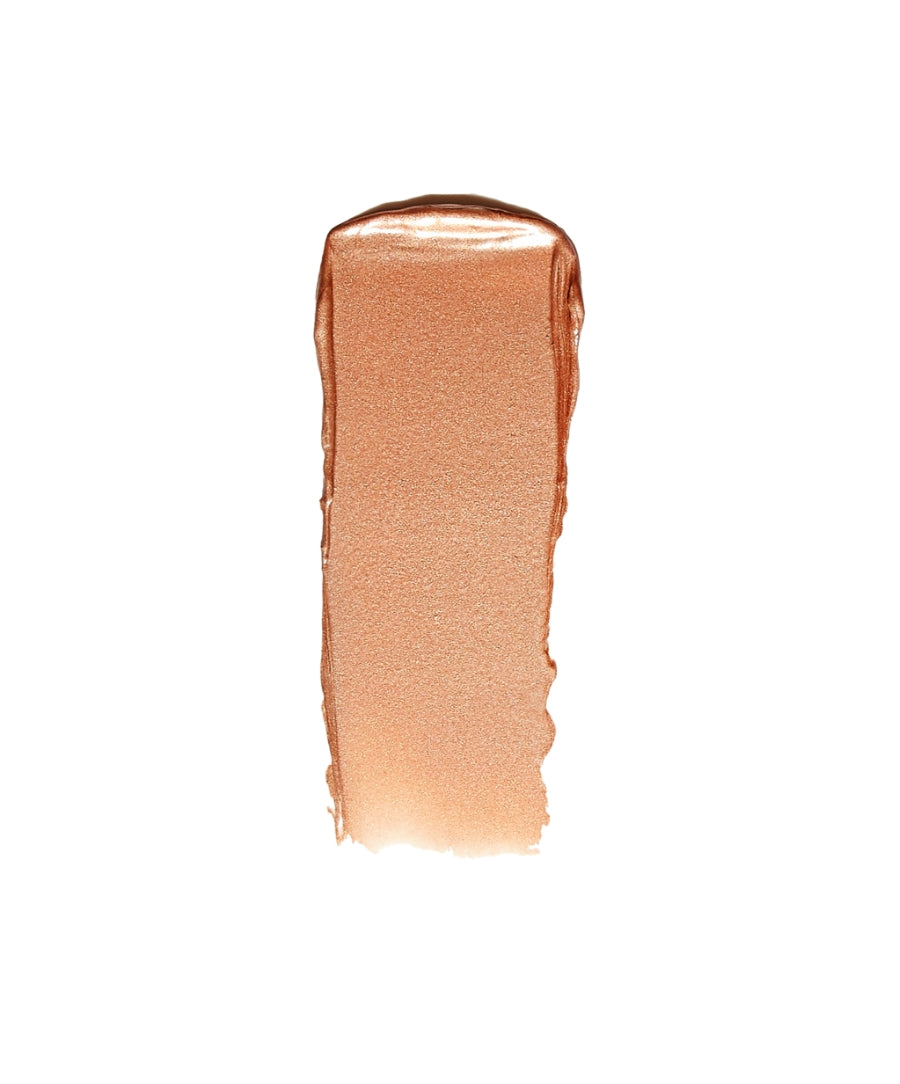 Peach-toned creamy makeup swatch showcasing a luminous, radiant finish for the Luminizer, highlighting clean beauty and natural ingredients appeal.