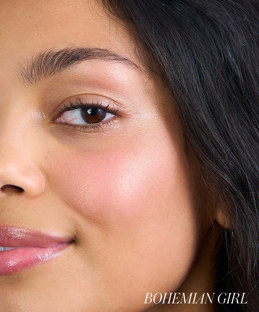 Close-up of a woman with natural makeup showcasing a soft pink flush on her cheek using ReDimension Hydra Powder Blush, highlighting clean beauty and skincare infused makeup.