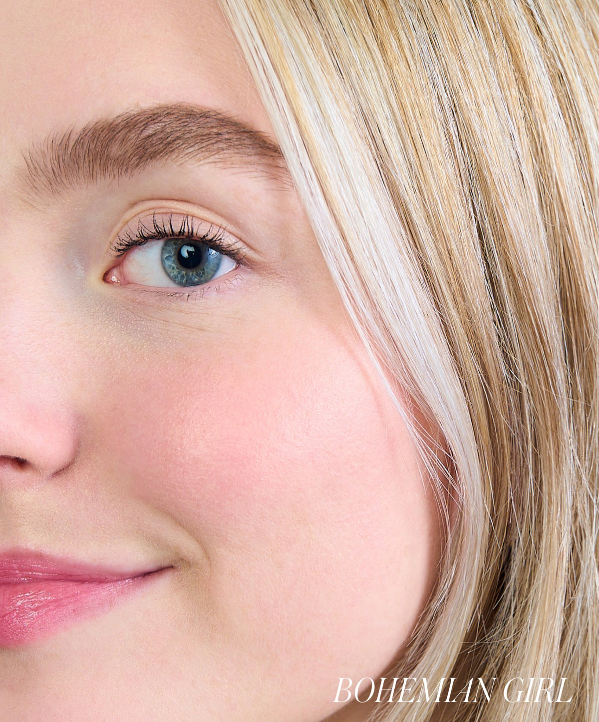 Close-up of a young woman with clear skin and natural makeup, showcasing a subtle rosy glow on her cheek enhanced by ReDimension Hydra Powder Blush.