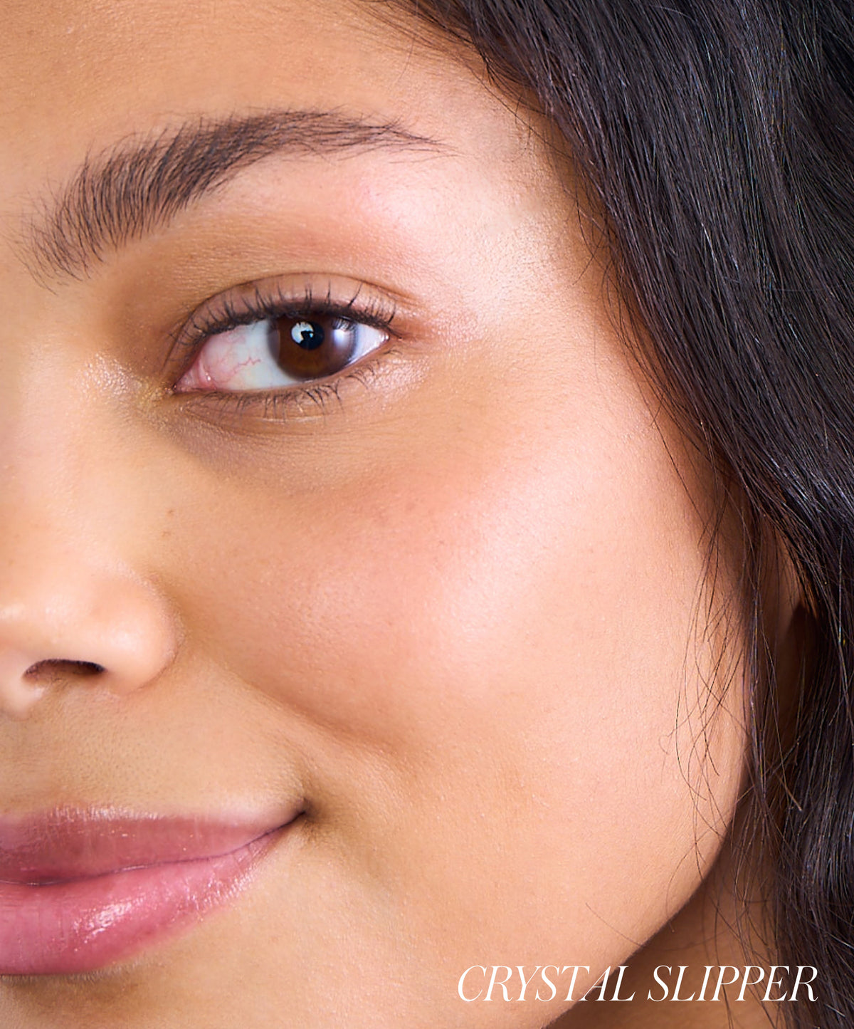 Close-up of a woman’s face showcasing natural, glowing skin with subtle blush applied, highlighting the effect of ReDimension Hydra Powder Blush in a clean beauty look.