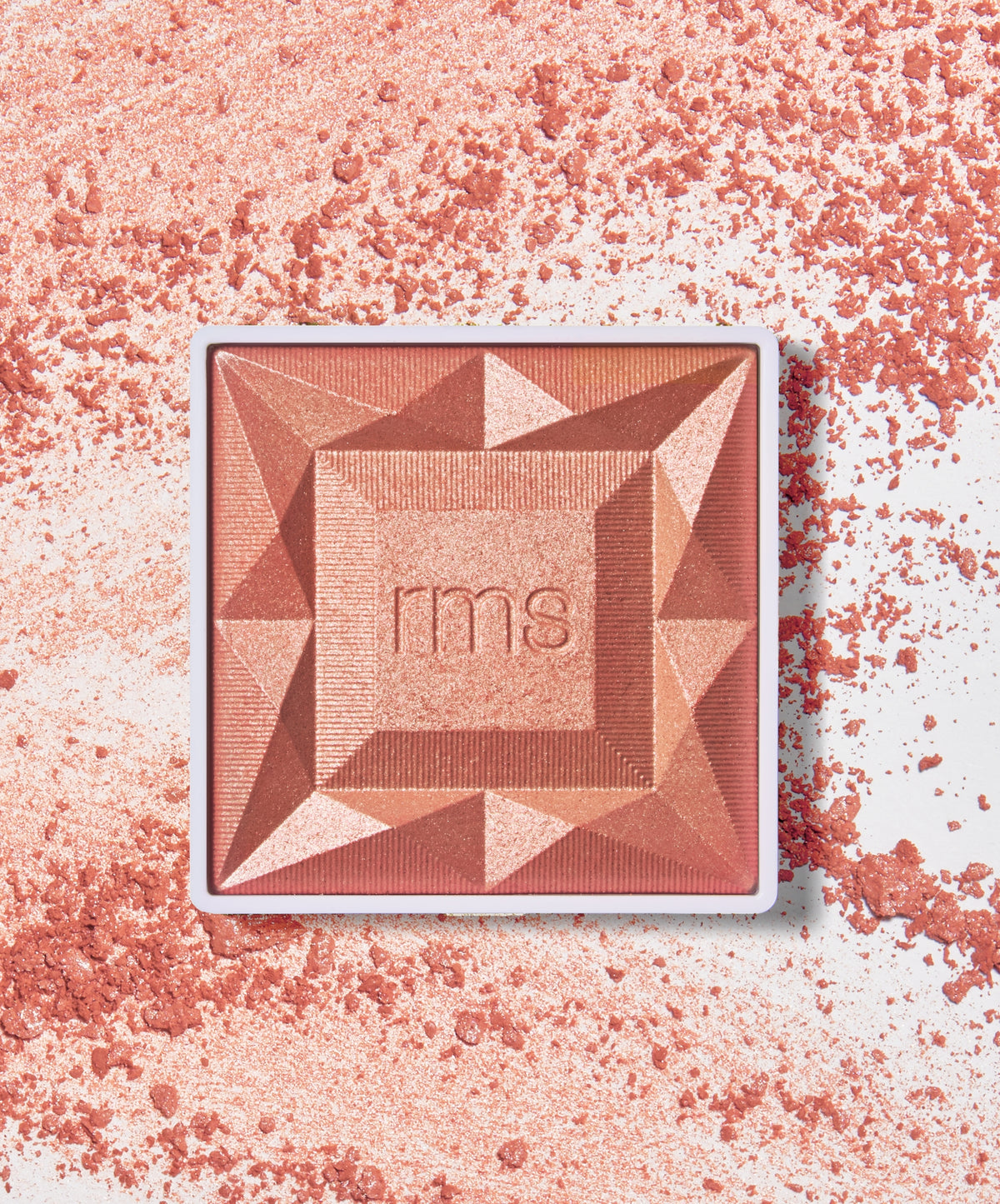 ReDimension Hydra Powder Blush in a geometric compact with a shimmery coral-pink powder surrounded by scattered blush powder, showcasing clean beauty and natural ingredients.
