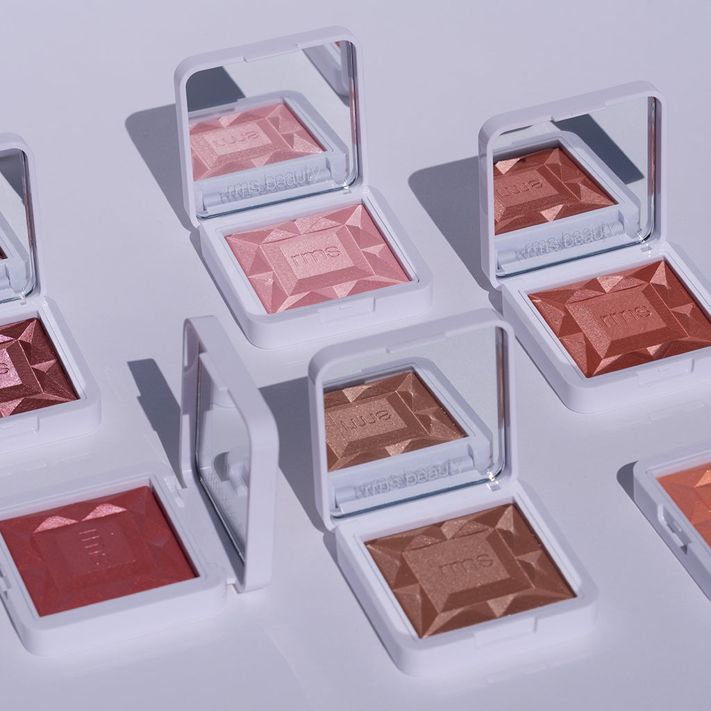 Open compacts of ReDimension Hydra Powder Blush in various natural shades with geometric embossed surface reflecting clean beauty and sustainable packaging values.