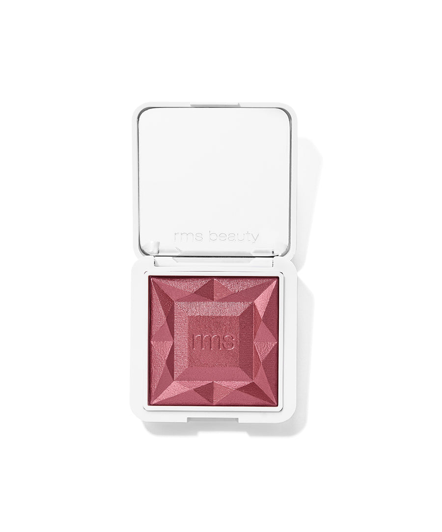 ReDimension Hydra Powder Blush in a deep pink shade with a faceted geometric surface embossed with rms logo, in a sleek white compact case designed for clean beauty and sustainable packaging.