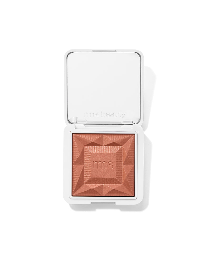 ReDimension Hydra Powder Blush in a warm terracotta shade with a sculpted geometric pattern, housed in a sleek white compact, featuring clean beauty and natural ingredients.