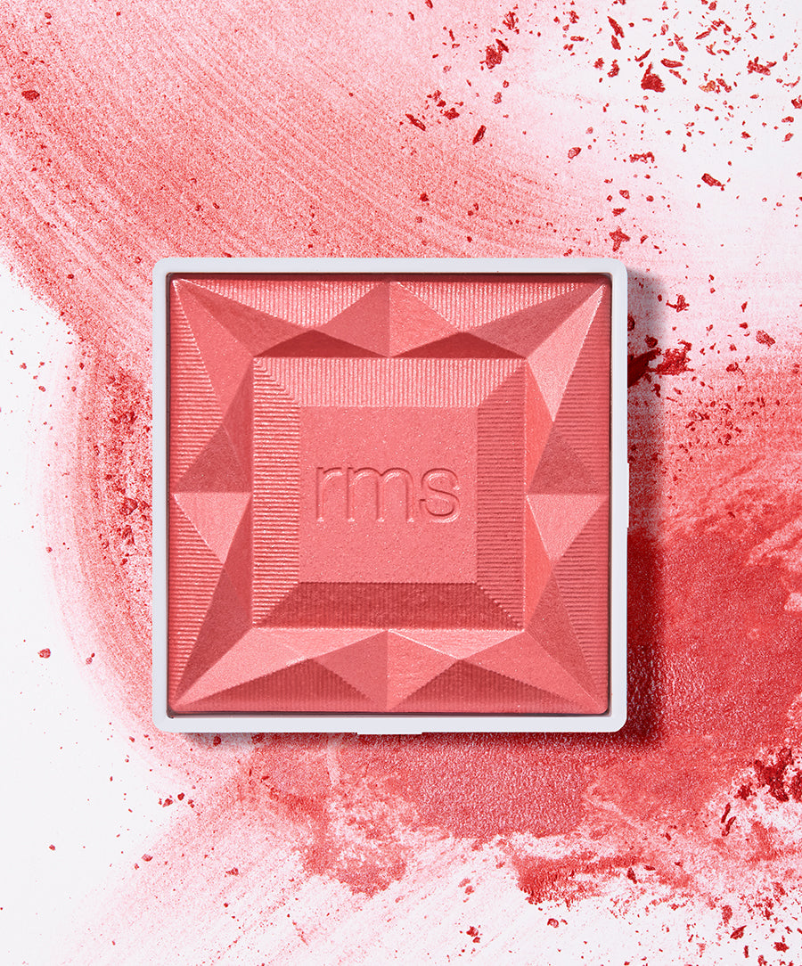 ReDimension Hydra Powder Blush in a coral-pink shade with geometric embossed design by RMS Beauty, showcasing clean beauty, natural ingredients, and sustainable packaging.