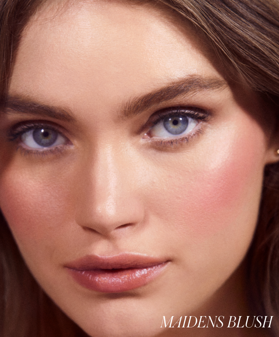 Close-up of a woman’s face featuring smooth skin with natural-looking rosy cheeks enhanced by ReDimension Hydra Powder Blush, highlighting clean beauty and skincare infused makeup.