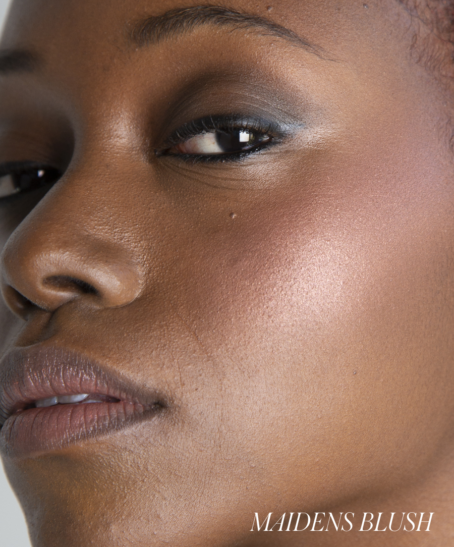 Close-up of a woman's face showcasing radiant skin with soft, natural makeup highlighting her cheek featuring ReDimension Hydra Powder Blush for a clean beauty look.